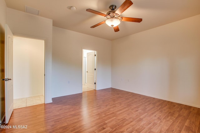 spare room featuring ceiling fan and light hardwood / wood-style flooring