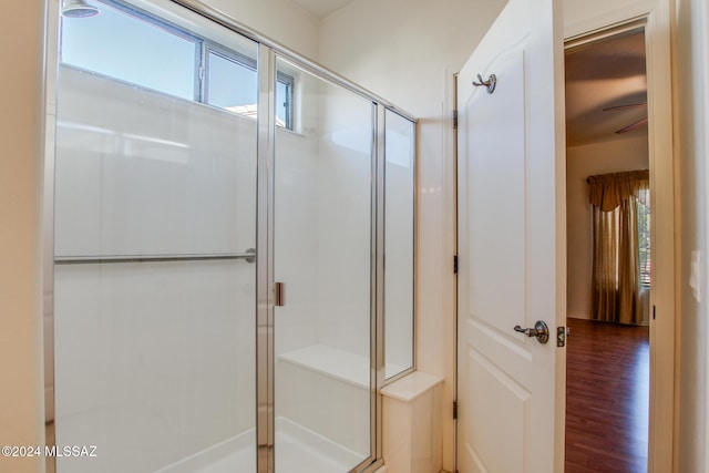 bathroom with an enclosed shower and wood-type flooring