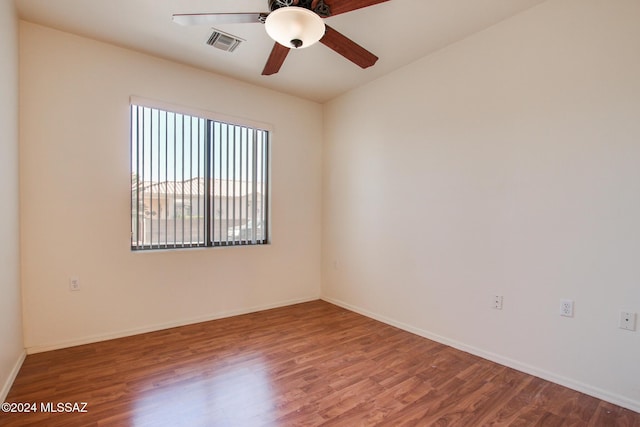 spare room with hardwood / wood-style flooring and ceiling fan