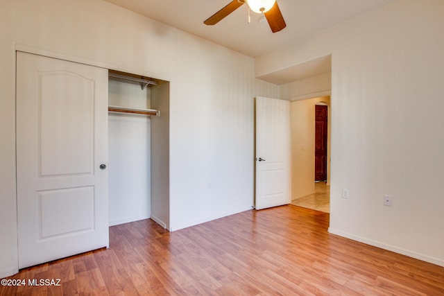 unfurnished bedroom with ceiling fan, a closet, and light wood-type flooring