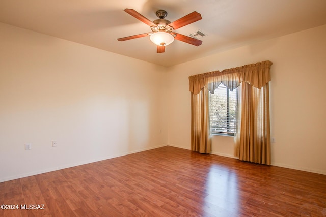 unfurnished room featuring hardwood / wood-style flooring and ceiling fan