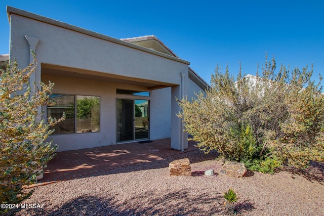 back of property featuring a patio area