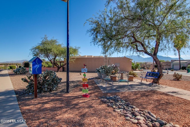 exterior space with a mountain view and a patio area