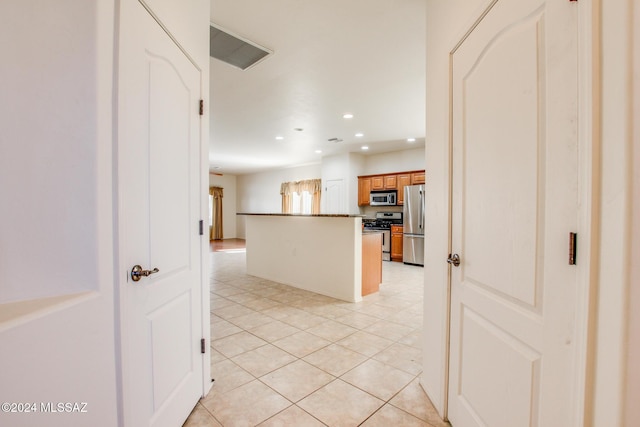 kitchen featuring appliances with stainless steel finishes and light tile patterned floors