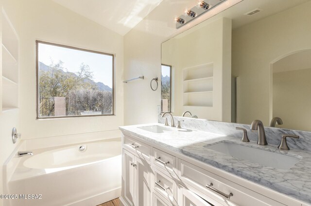 kitchen with visible vents, lofted ceiling, light wood-style floors, white cabinets, and stainless steel appliances