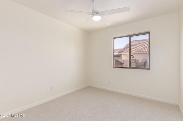 carpeted bedroom with multiple windows, ceiling fan, baseboards, and vaulted ceiling