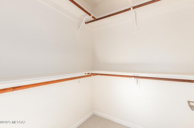 unfurnished room featuring baseboards, light colored carpet, and ceiling fan