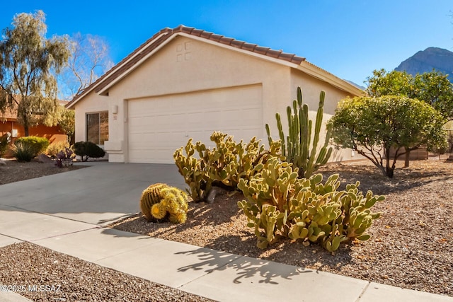 view of front of property with stucco siding, a garage, and concrete driveway