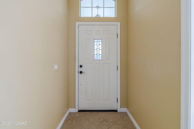 doorway to outside featuring light tile patterned floors and plenty of natural light