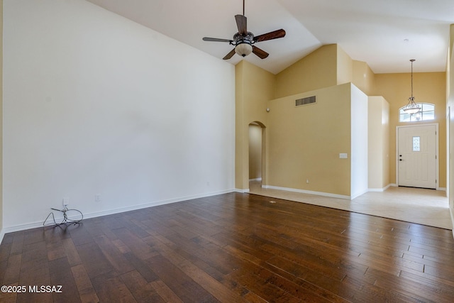 unfurnished living room featuring dark hardwood / wood-style floors, ceiling fan, and high vaulted ceiling