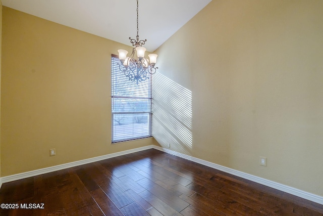 unfurnished room with dark hardwood / wood-style floors, an inviting chandelier, and lofted ceiling