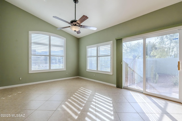 unfurnished room featuring ceiling fan, light tile patterned floors, and lofted ceiling