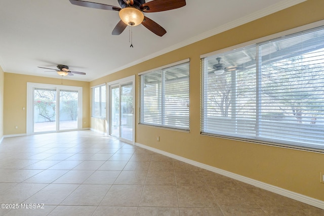 unfurnished room featuring ceiling fan, light tile patterned floors, and crown molding