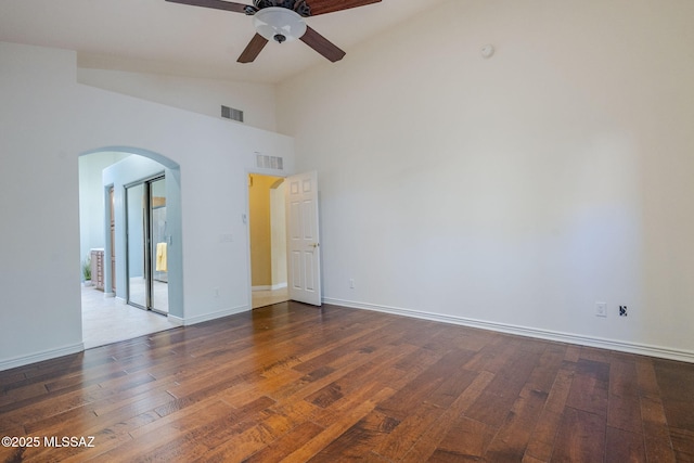 unfurnished room featuring vaulted ceiling, ceiling fan, and dark wood-type flooring