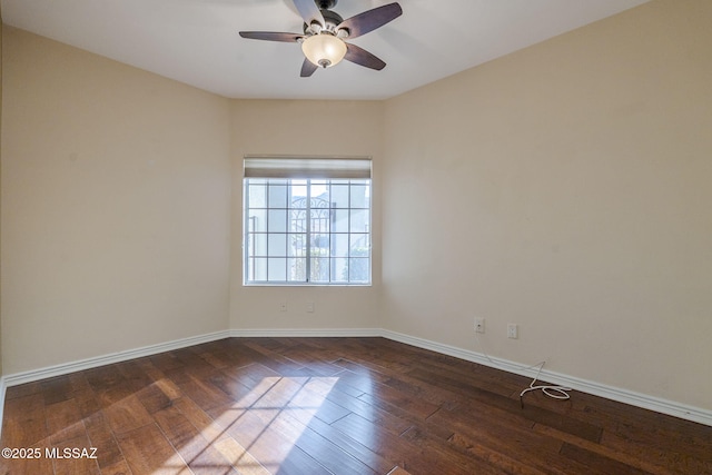 empty room featuring ceiling fan and dark hardwood / wood-style flooring