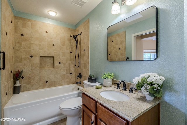 full bathroom with vanity, toilet, and tiled shower / bath combo