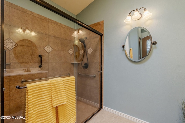 bathroom featuring tile patterned floors and a shower with shower door