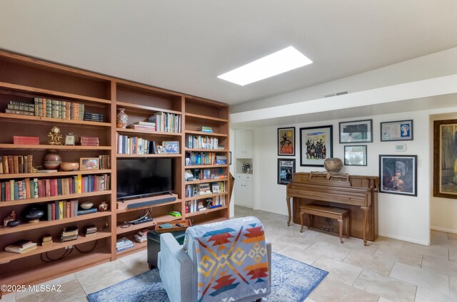 dining area featuring an inviting chandelier, beam ceiling, and light tile patterned flooring