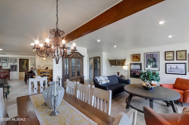 dining space with beam ceiling and a chandelier