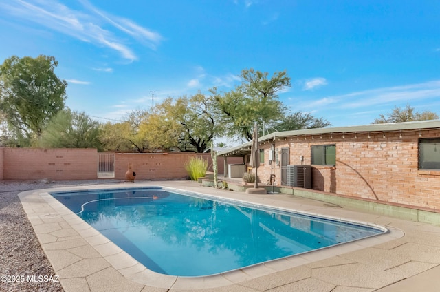 view of swimming pool with central AC and a patio area