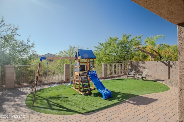 view of jungle gym featuring a lawn