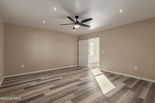 unfurnished room with ceiling fan and wood-type flooring