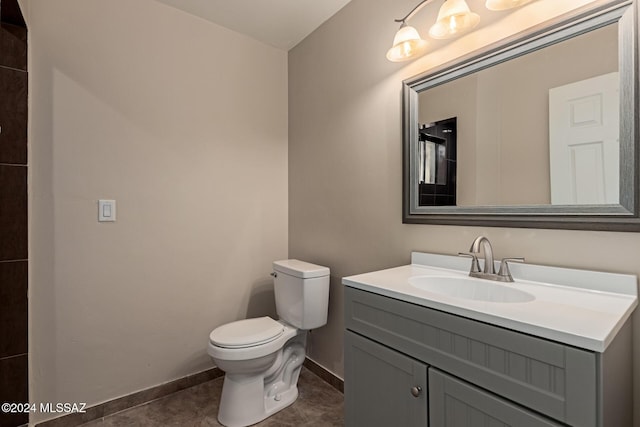 bathroom featuring tile patterned flooring, vanity, and toilet