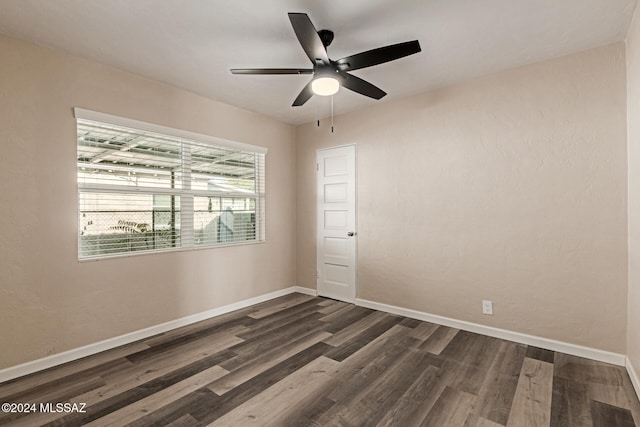 unfurnished room featuring ceiling fan and dark hardwood / wood-style floors