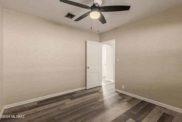 empty room featuring dark hardwood / wood-style floors and ceiling fan