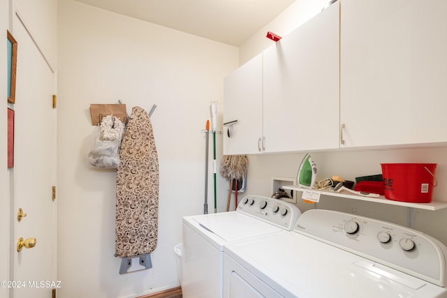 laundry area featuring cabinets and washing machine and dryer