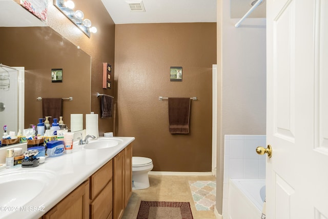 bathroom with tile patterned floors, vanity, toilet, and a bath