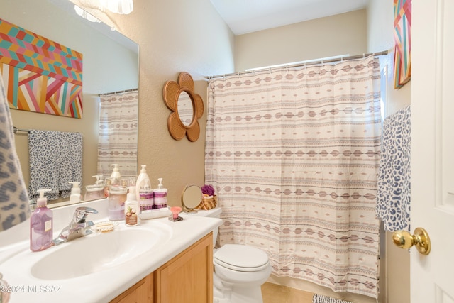 bathroom with vanity, curtained shower, and toilet