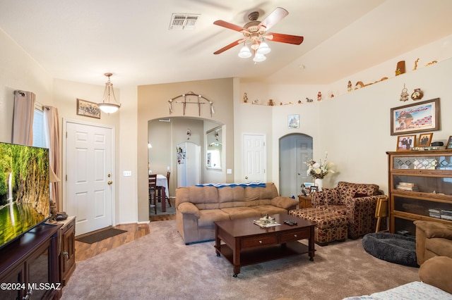 living room with hardwood / wood-style floors, ceiling fan, and lofted ceiling