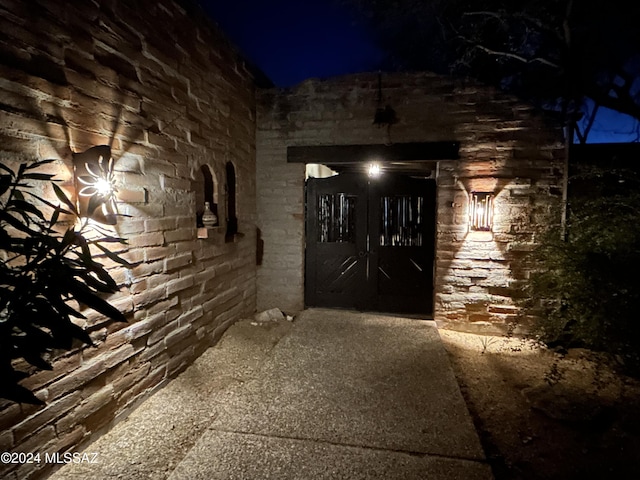 view of exterior entry at night