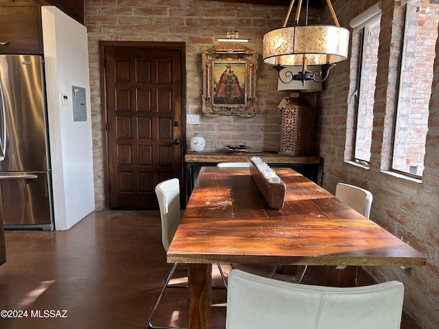 dining space featuring concrete flooring