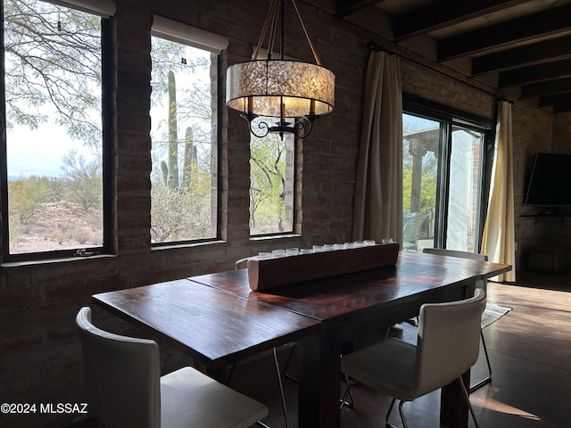 dining area with beamed ceiling and a healthy amount of sunlight