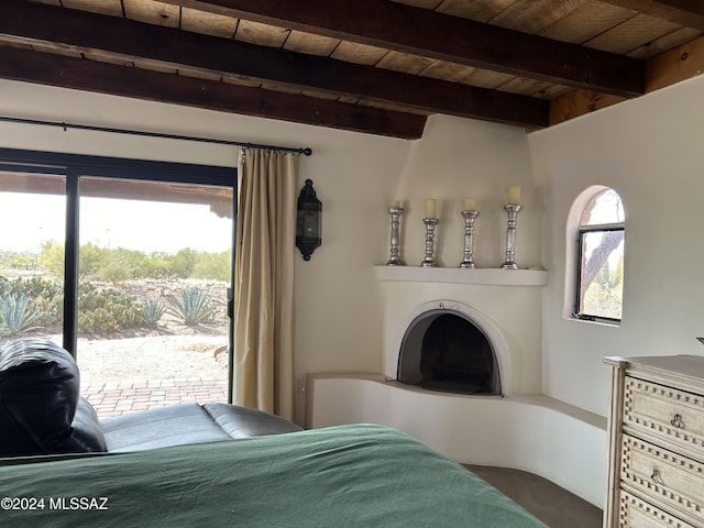 bedroom with beam ceiling, wood ceiling, and access to outside