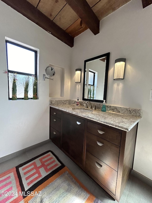 bathroom with beamed ceiling, vanity, and wood ceiling