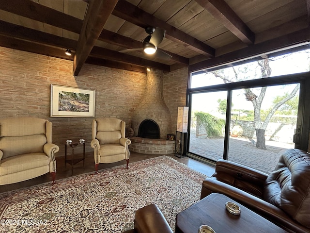 living room with a fireplace, beam ceiling, ceiling fan, and wooden ceiling