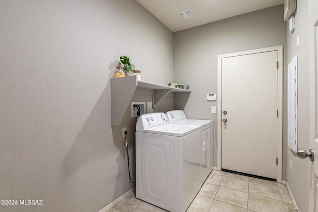 washroom with light tile patterned flooring and washing machine and clothes dryer