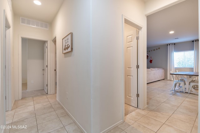 hall with light tile patterned floors