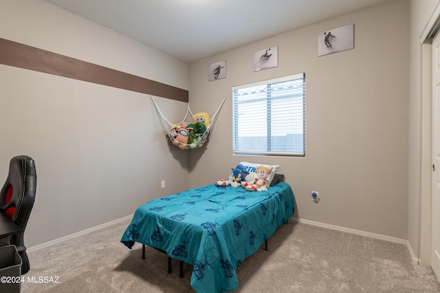 bedroom featuring light colored carpet