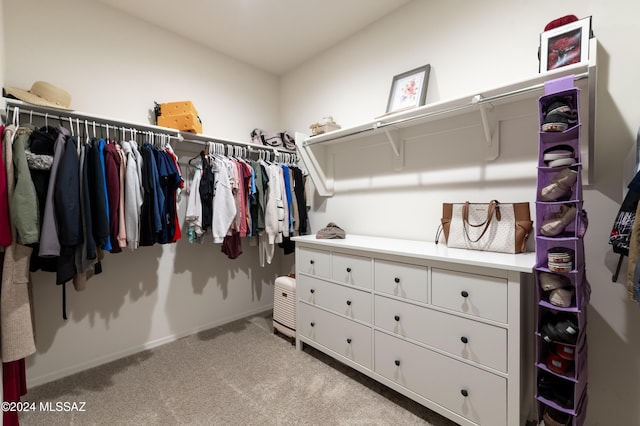 spacious closet featuring light carpet