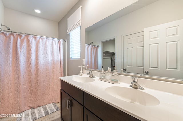 bathroom featuring tile patterned flooring and vanity