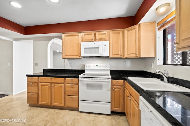 kitchen featuring white appliances, sink, and light tile patterned floors