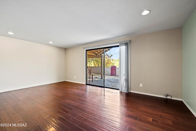 unfurnished room with dark hardwood / wood-style flooring