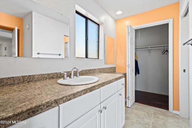 bathroom featuring tile patterned flooring and vanity