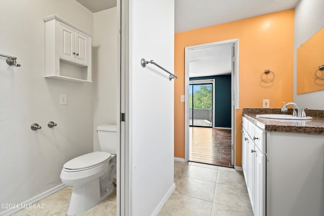 bathroom with tile patterned floors, vanity, and toilet