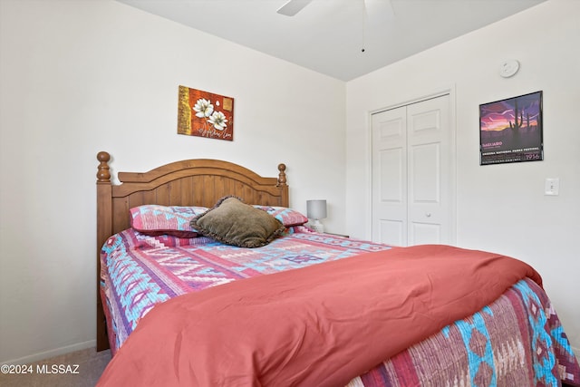 carpeted bedroom with ceiling fan and a closet