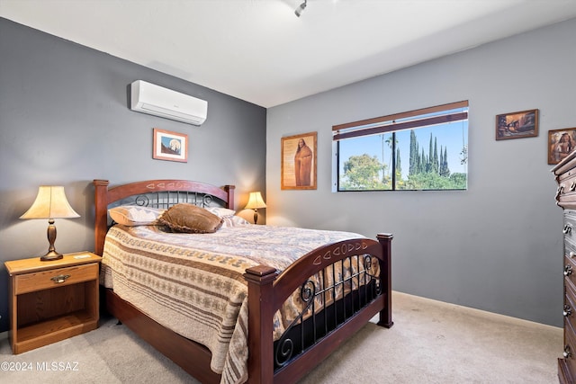 bedroom featuring a wall unit AC and light carpet